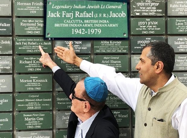 An Israeli official pointing at the ammunition box on which J. F. R. Jacob