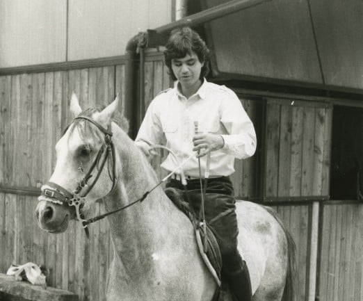 An old picture of Andrea Bocelli while riding a horse