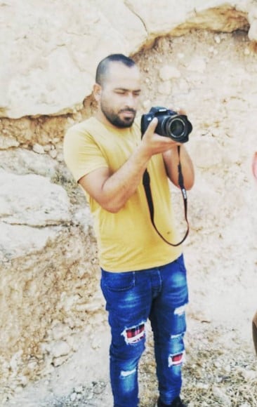 An old picture of Hamdan Ballal while working as a photographer
