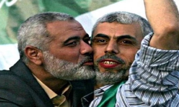 An old picture of Ismail Haniyeh kissing Yahya Sinwar