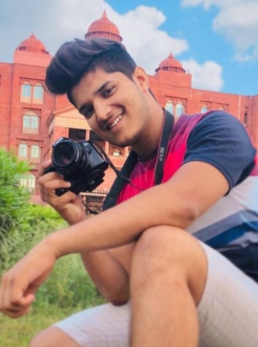 An old picture of Mridul Tiwari posing with his camera