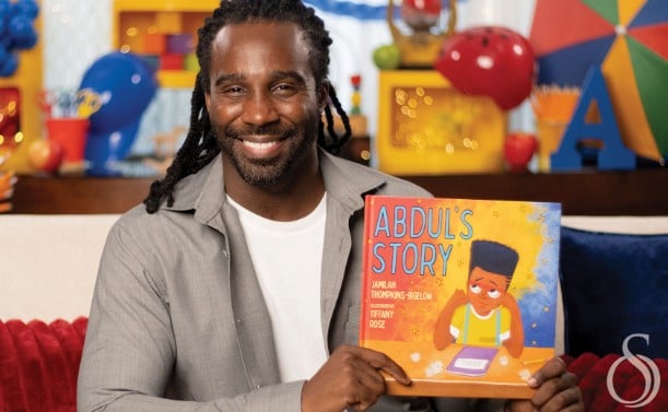 An old picture of Tramell Tillman while reading a story book at the SAG-AFTRA Foundation’s children’s literacy program