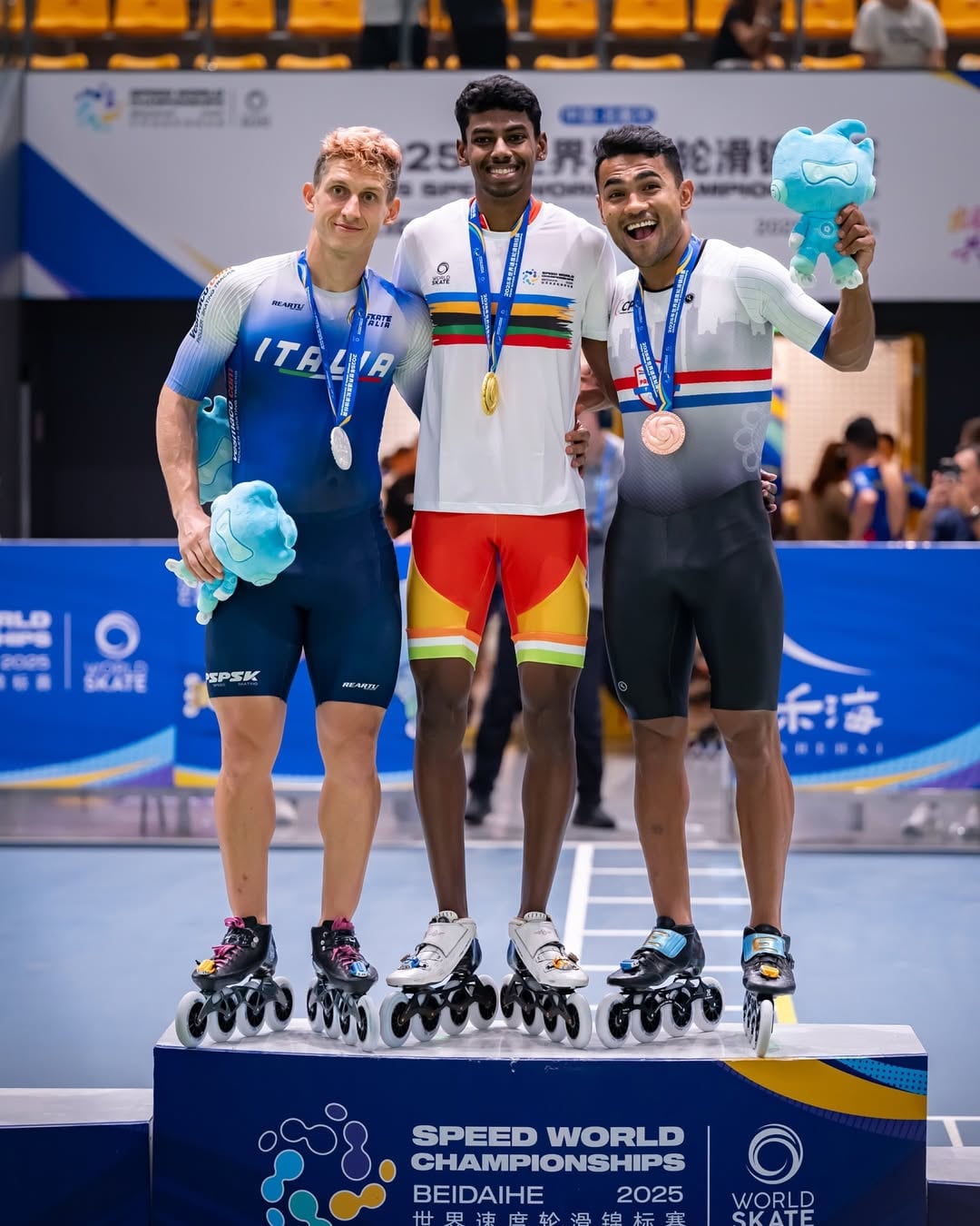 Anandkumar Velkumar (middle) at victory ceremony