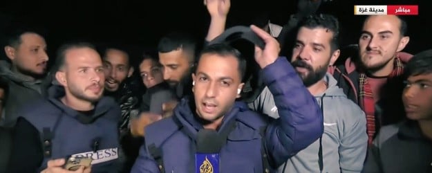 Anas Al-Sharif while reporting live on the Gaza war ceasefire and taking off his protective gear