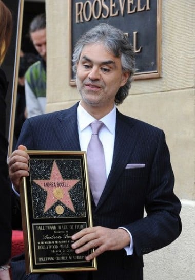 Andrea Bocelli posing with his star on the Hollywood Walk of Fame