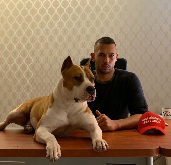 Andrew Tate posing with his pet dog