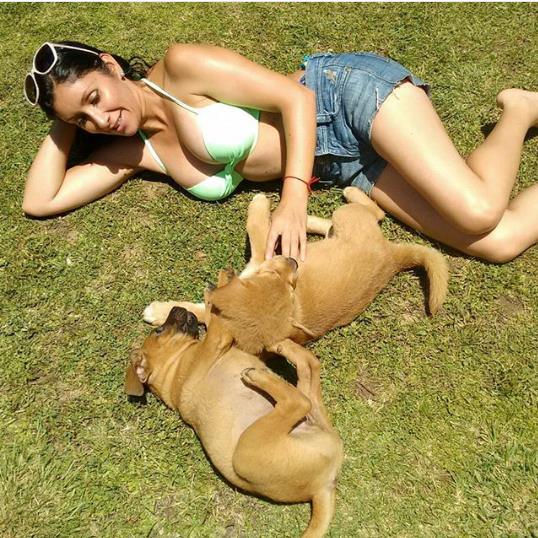Angélica Sepúlveda posing with her pet dogs