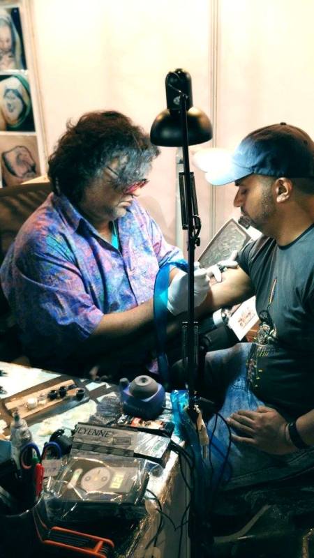 Anil Gupta while making a tattoo for a client