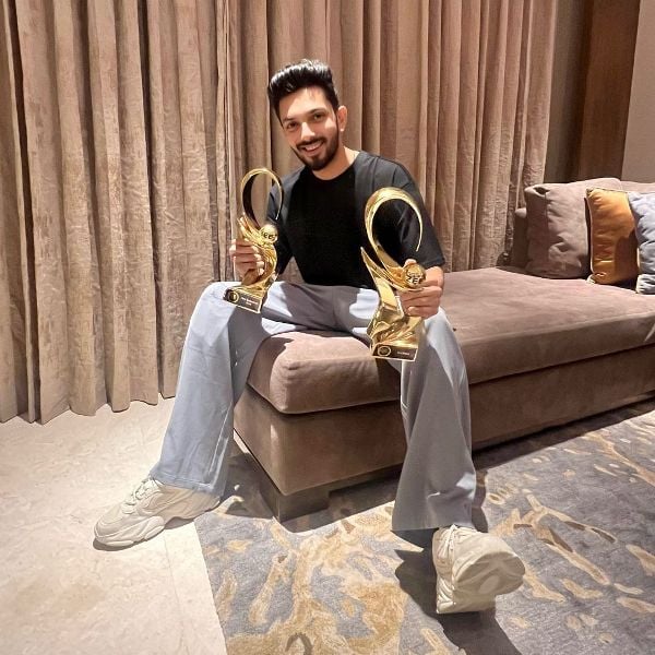 Anirudh Ravichander while posing with the awards, which he won at the 2024 Zee Cine Awards