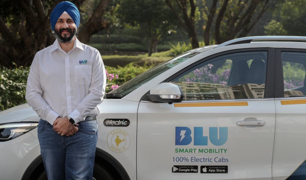 Anmol Singh Jaggi posing with BluSmart electric cab