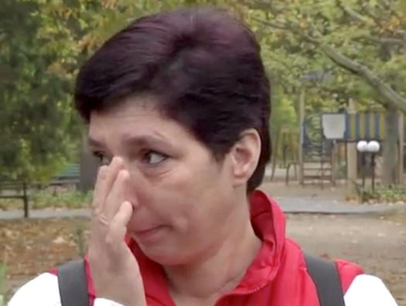 Anna Volodymyrivna Gava wiping off her tears while talking about her daughter during the interview