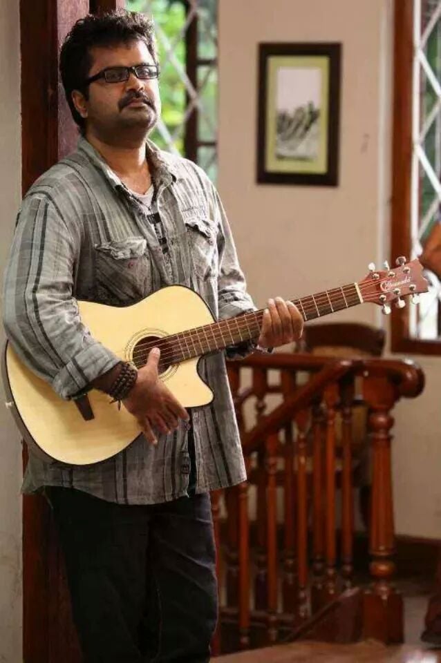 Anoop Menon playing guitar