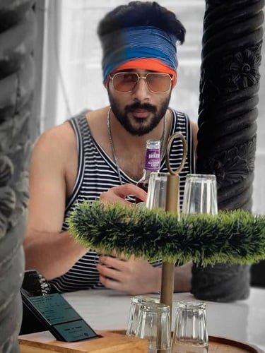 Anson Paul holding a bottle of alcohol