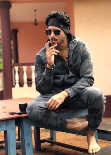 Anson Paul smoking a cigarette