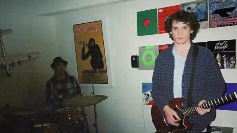 Anton Yelchin while playing the guitar