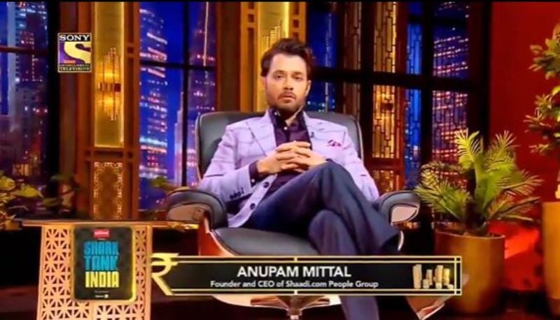 Anupam Mittal posing as a judge of the busniess reality show Shark Tank