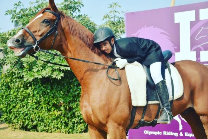 Anush Agarwalla riding a horse during his early teenage years