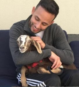 Anwar Jibawi cuddling a goat
