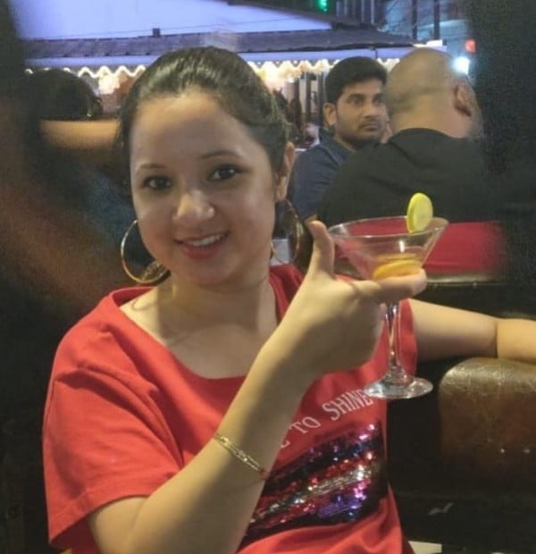 Aparna Moazzam holding an alcoholic drink
