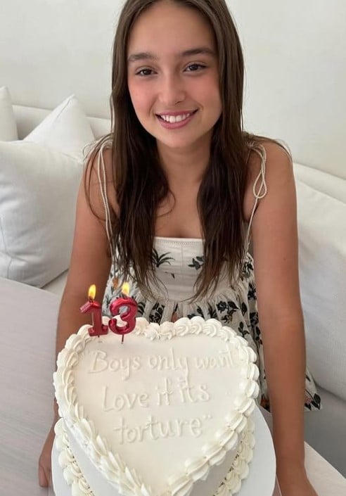 Arabella Rose Kushner posing with her 13th birthday cake