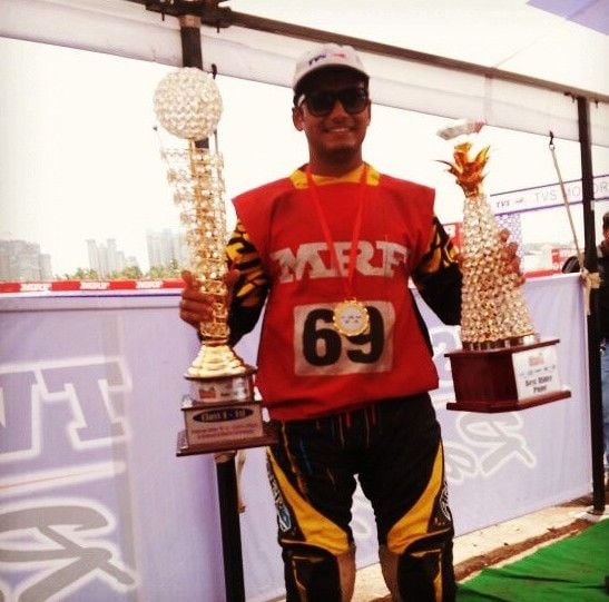 Aravind KP posing with awards at MRF Championship