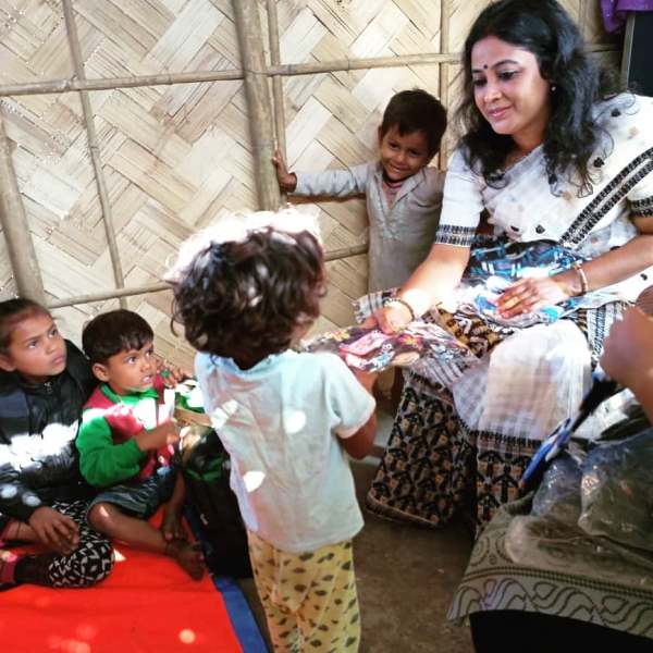 Archana Borthakur while distributing winter clothes to children