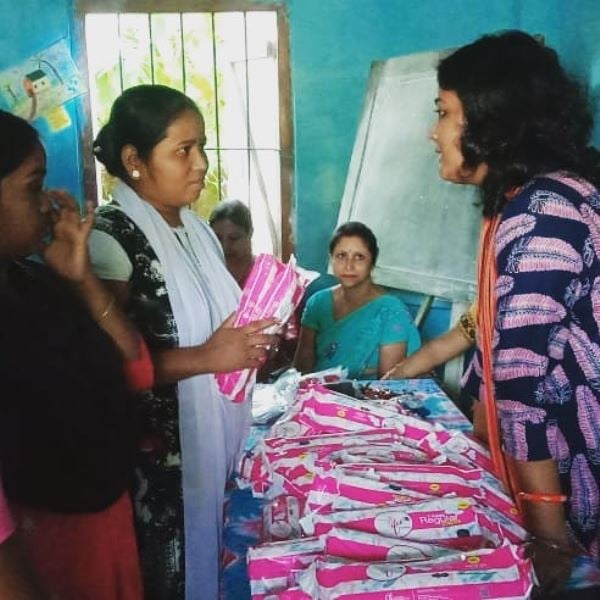 Archana Borthakur (right) while distributing sanitary napkins in an awareness camp