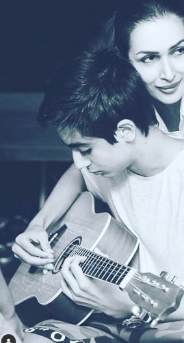 Arhaan Khan playing a guitar