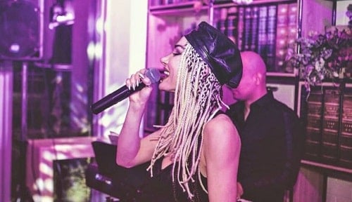 Arjeta Palushaj performing at a live event