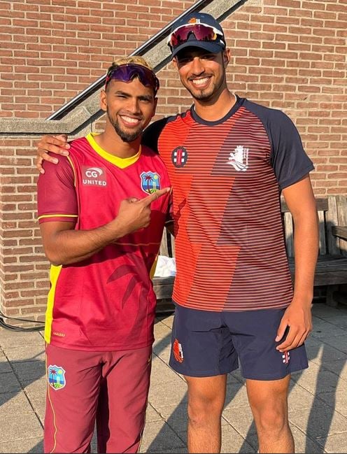 Aryan Dutt with Nicholas Pooran (left)