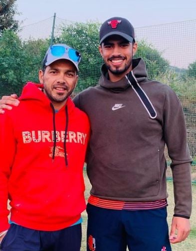 Aryan Dutt with his coach, Amit Uniyal (left)