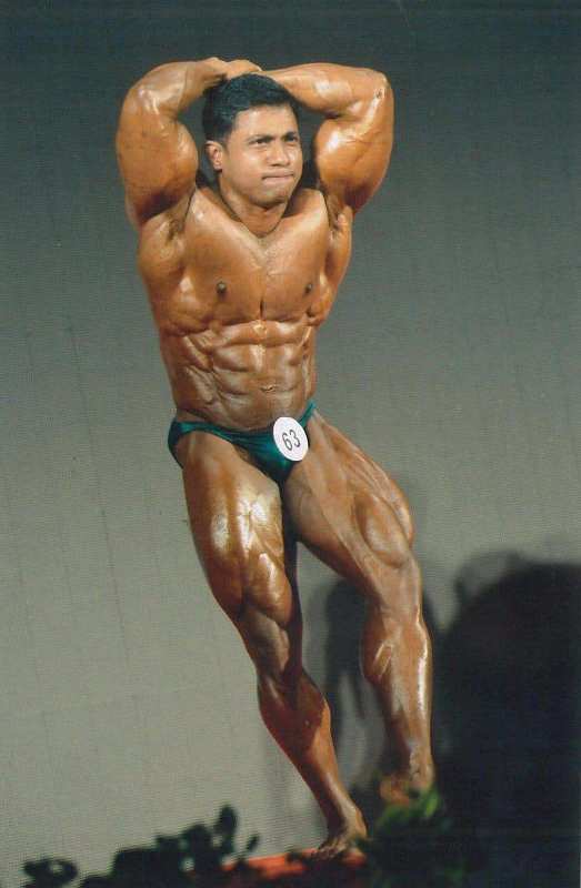 Ashish Sakharkar posing at a bodybuilding competition