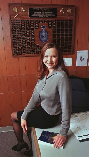 Ashley Moody posing in her presidential office of the Florida Blue Key