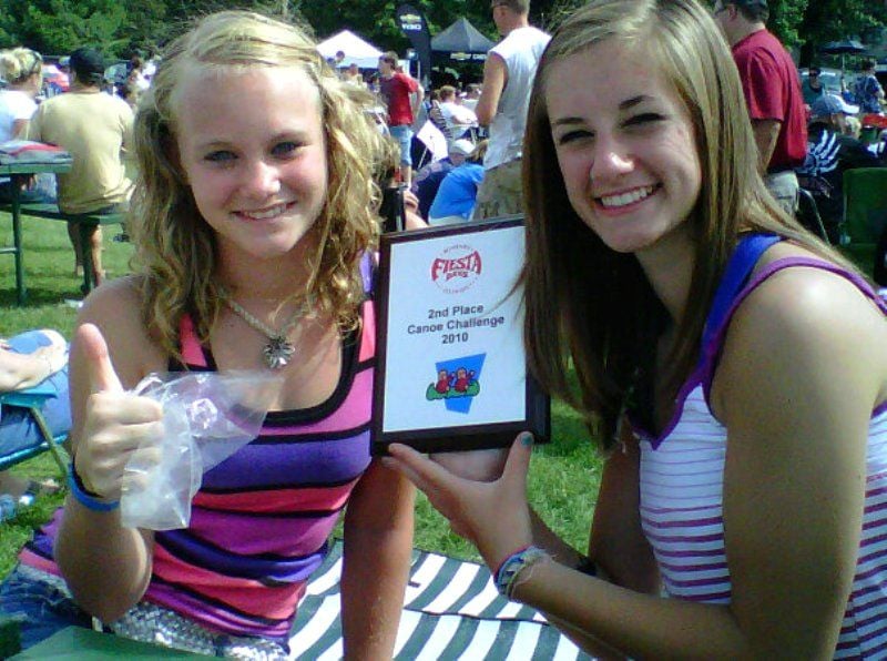 Ashley Moore (left) and her friend Jessie with their prize for finishing second in a canoe race in 2010