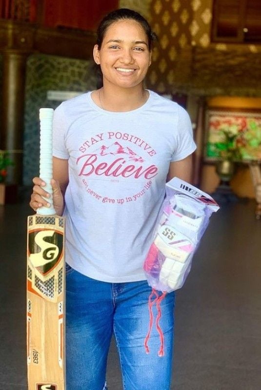 Ashwani Kumari with a bat and pair of gloves