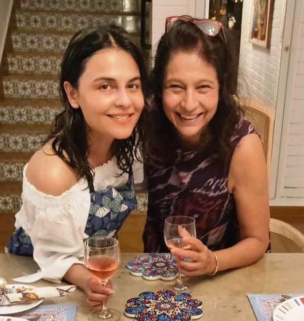 Asmita Marwa holding a glass of wine