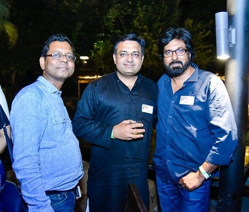 Atul Agrawal holding a glass of alcohol