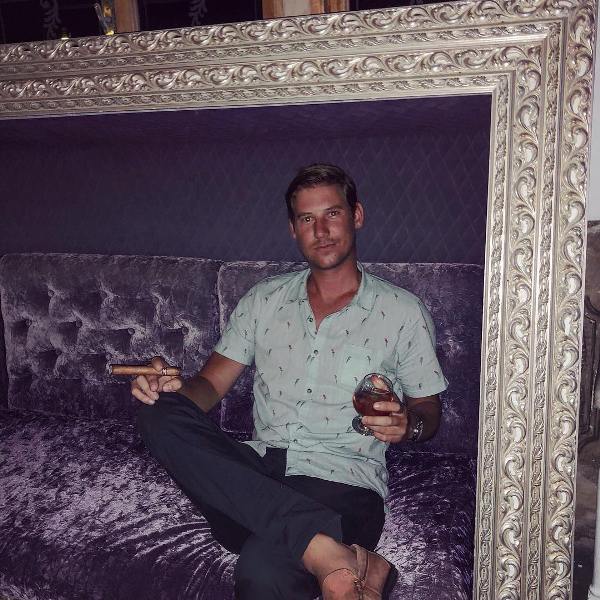 Austen Kroll while smoking a cigar