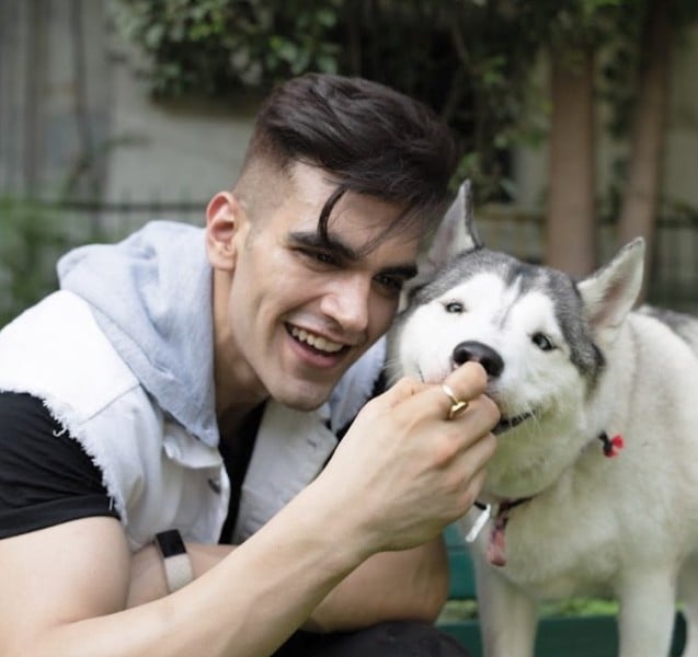 Aviral Gupta playing with a dog