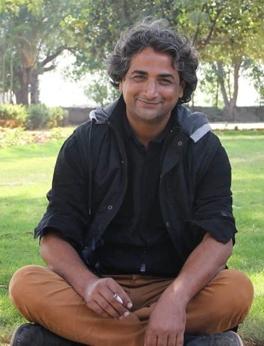 Azhar Iqbal holding a cigarette