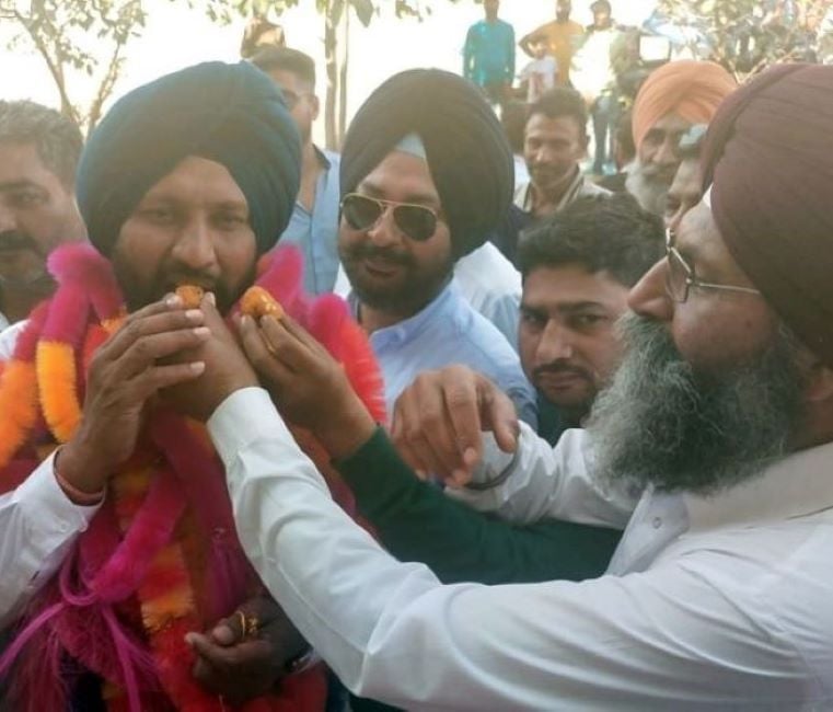 Balkar Singh celebrating with his supporters after winning the election