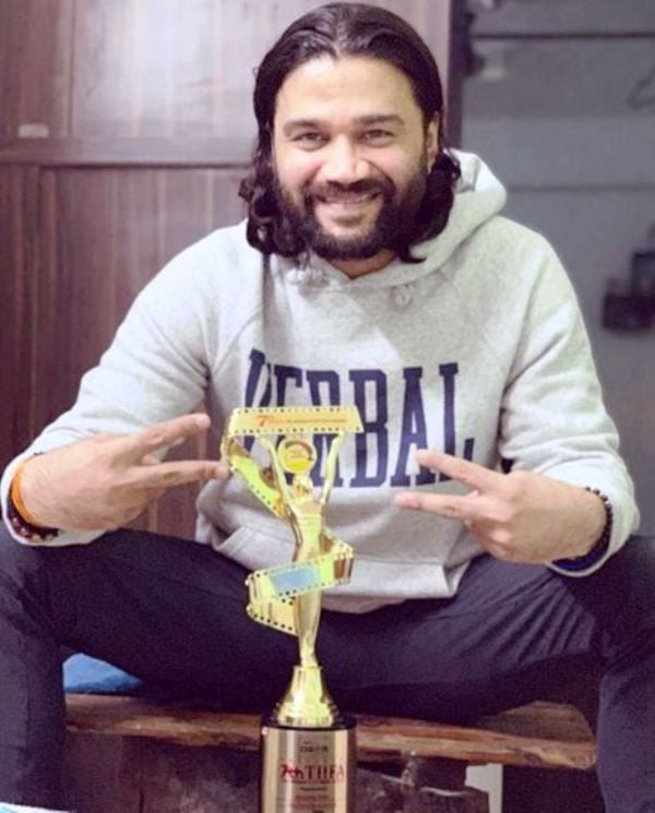Balraj Syal Posing with His Award