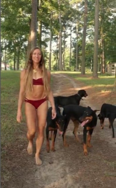 Barbara Johnson walking with her Dobermans