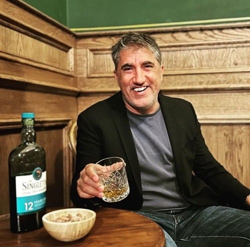 Bashar Rahal holding a glass of alcohol