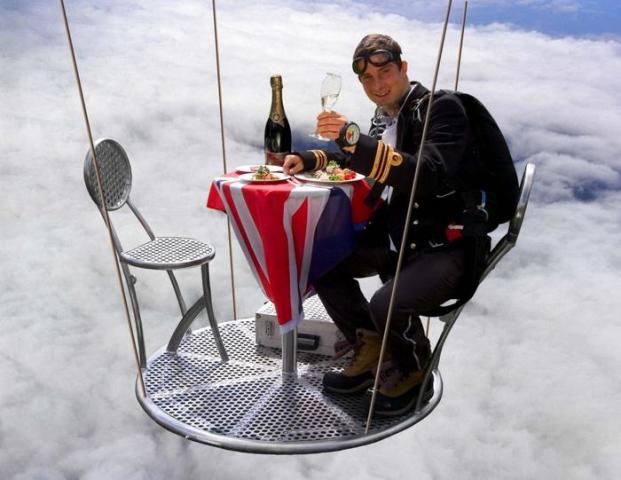 Bear Grylls having dinner in air