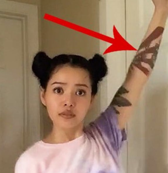 Bella Poarch featuring the controversial Rising Sun Flag tattoo on her arm