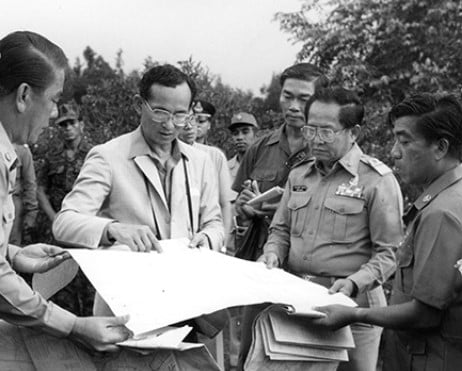 Bhumibol Adulyadej while discussing a project