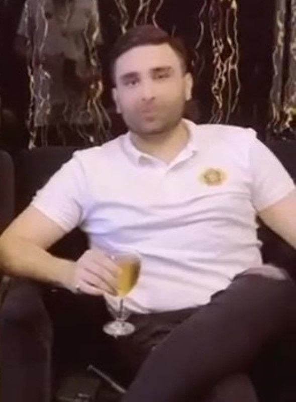 Bilal Shah holding a glass of alcohol