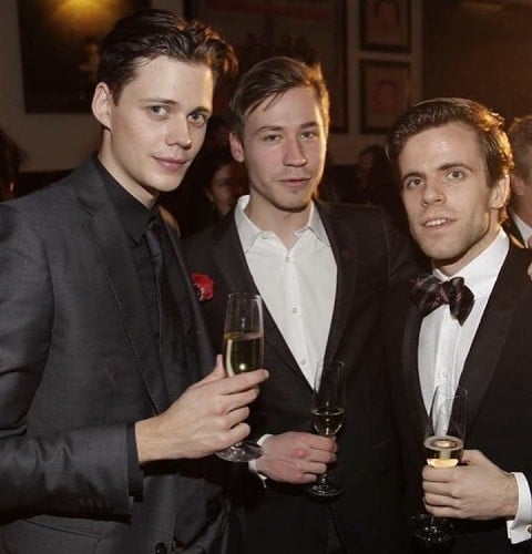 Bill Skarsgård holding a glass of wine