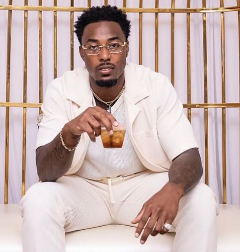 Brion Whitley holding a glass of alcohol